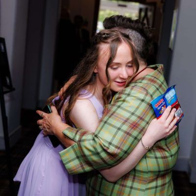 Scottish Celebrant Isabel Lockhart hugging bridesmaid.